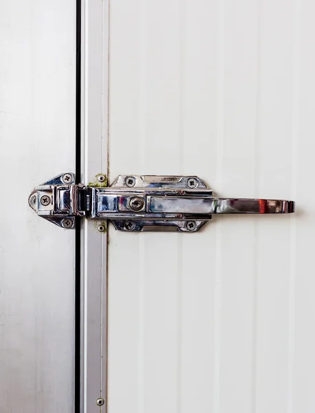 Aluminum door knob on the door of electric control in cooling ro — Stock Photo, Image