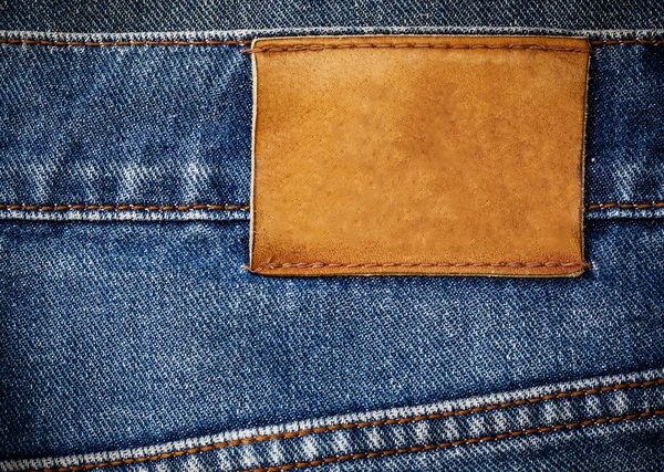 Staré džíny textury s koženými label pozadí zblízka — Stock fotografie