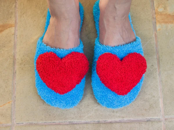 Blue shoes in house with red heart on floor at home — Stock Photo, Image