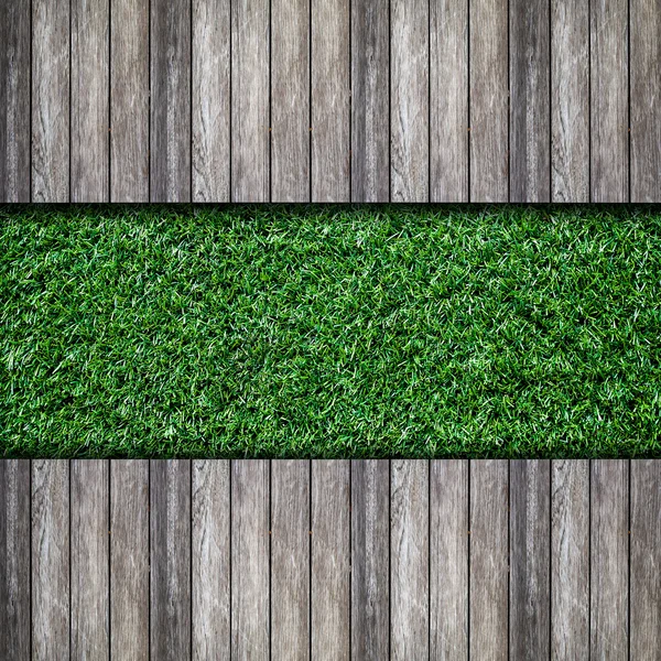 Old wooden with green grass background — Stock Photo, Image