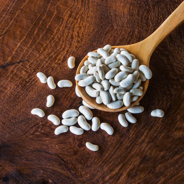 Close up bean seed spoon on wood table — Stock Photo, Image