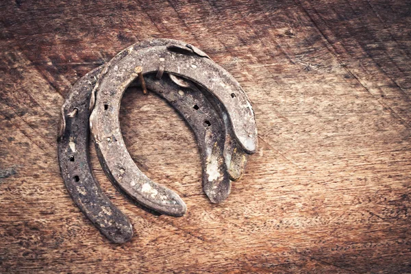 Old horseshoe on wood for vintage style — Stock Photo, Image