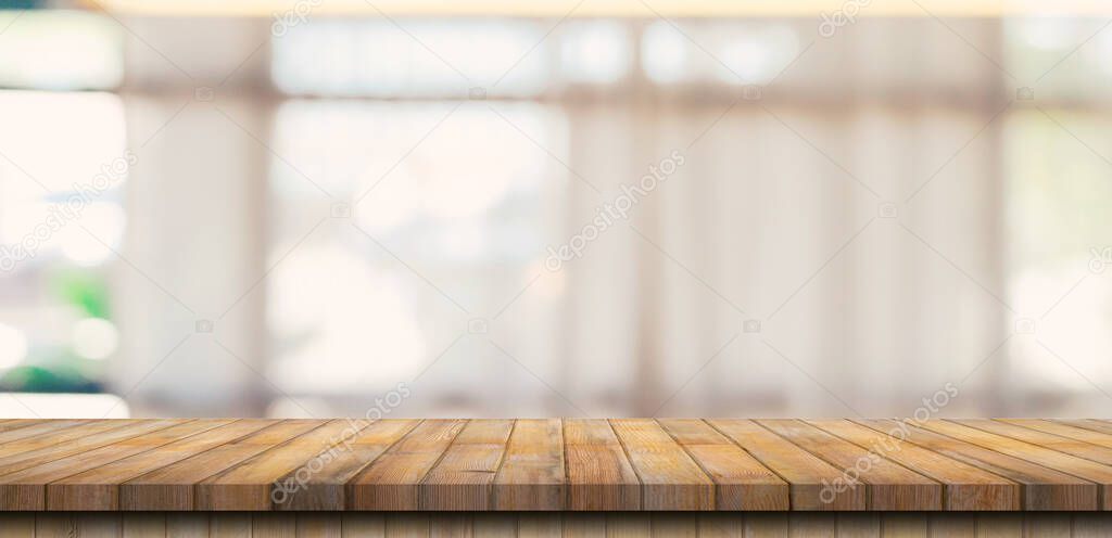 Wooden table top with blurred people in coffee shop and cafe background for display montage, copy space.