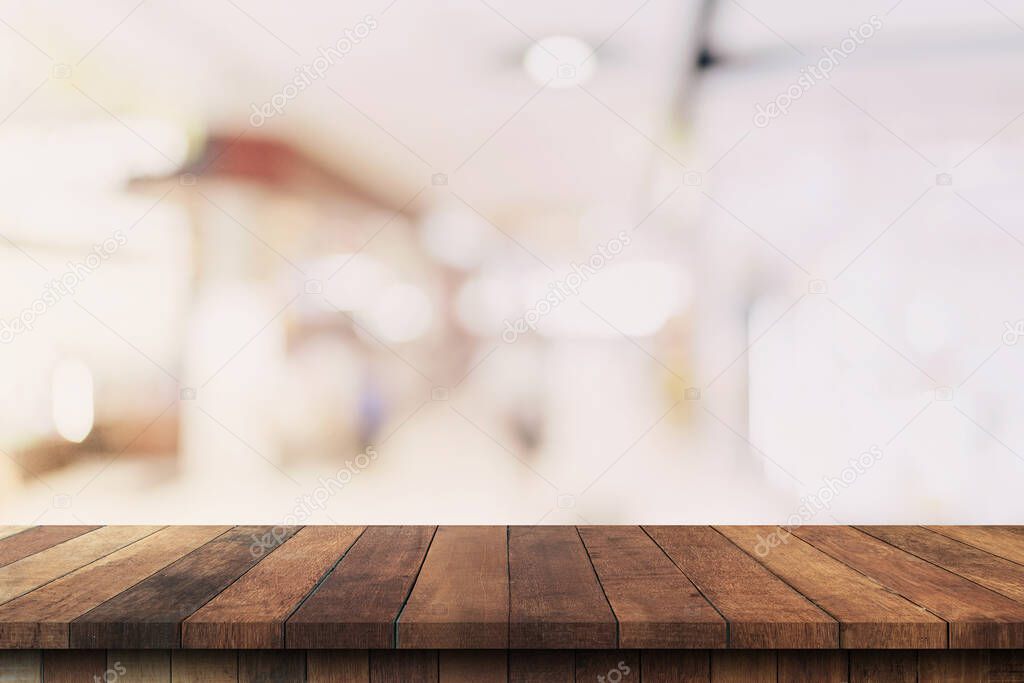 Wood table top on blurred background from shopping mall, Space for montage your product.