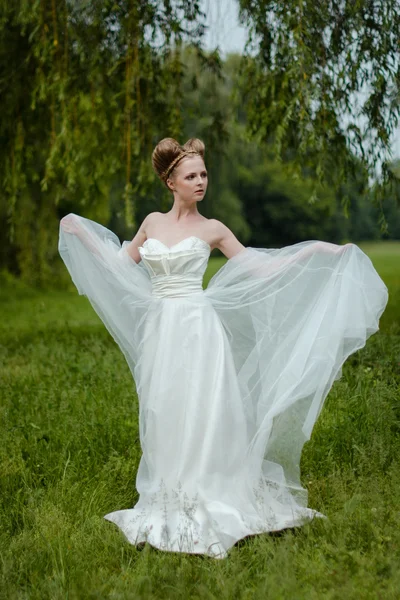 Beautiful blond bride in fashionable wedding dress — Stock Photo, Image