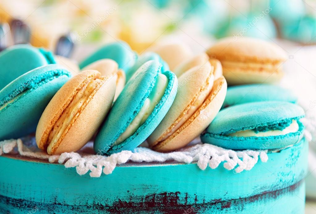 Colored macaroon on gift box. Photo toned style