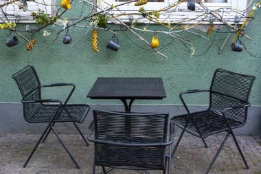 Empty table in outdoor cafe or restaurant. Tables and chairs at sidewalk cafe. Touristic setting, cafe table, sidewalk cafe furniture