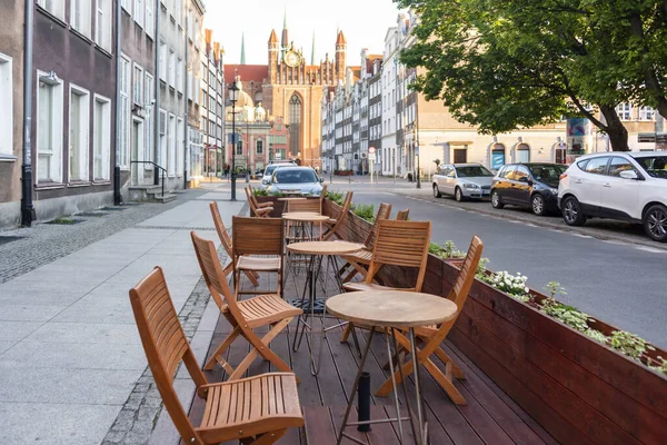 Empty table in outdoor cafe or restaurant. Tables and chairs at sidewalk cafe. Touristic setting, cafe table, sidewalk cafe furniture