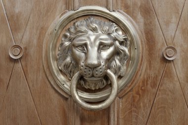 Door knocker made as lions head clipart