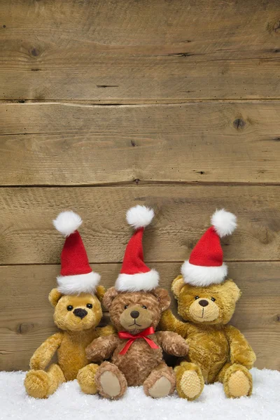Три плюшевих ведмеді з різдвяними капелюхами — стокове фото