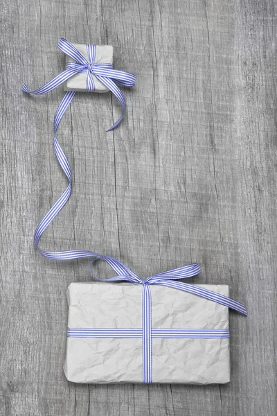 Giftboxes with blue striped ribbon — Stock Photo, Image