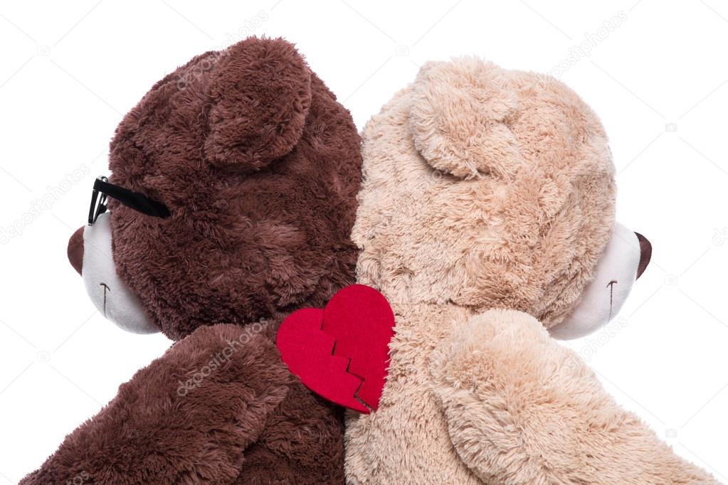 Teddy bears back to back for support