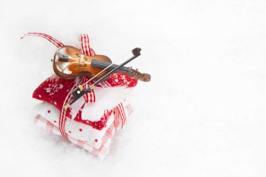 Three bean bag with ribbon and violin on white background for ch clipart