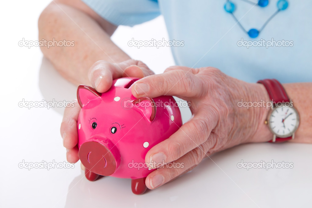 Pensioner holding her piggy bank