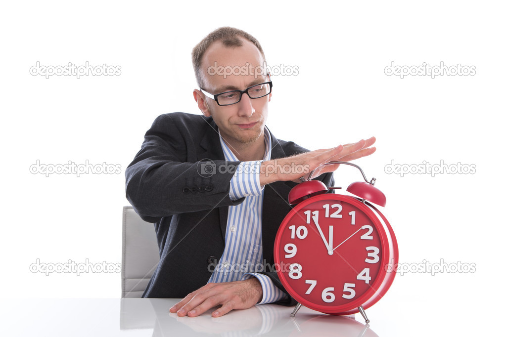 Businessman stopping time on red clock isolated