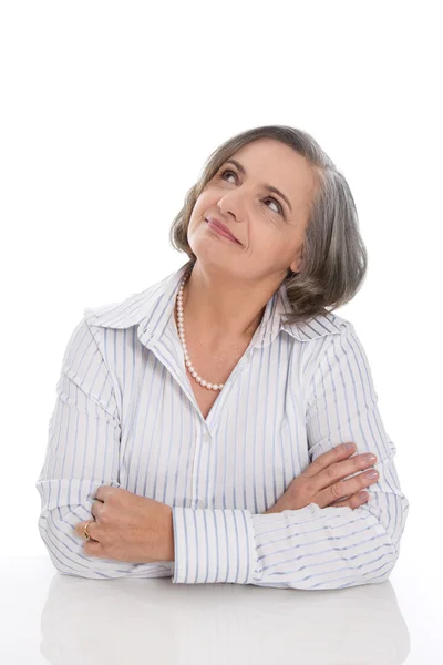 Senior woman folding arms and fond memories — Stock Photo, Image