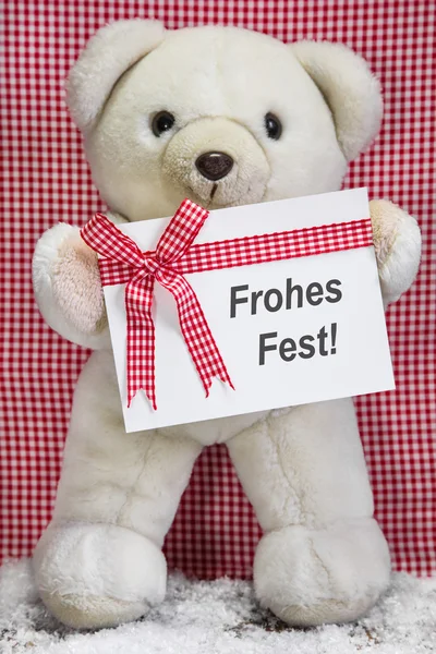 Urso de pelúcia com um cartão de saudação xadrez vermelho e branco para chritmas - Frohes Fest — Fotografia de Stock