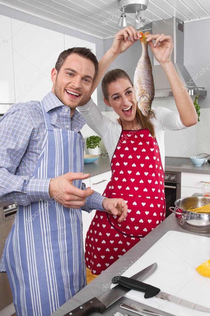 Young married couple in the kitchen - have fun and cooking fresh