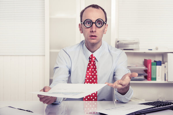 Businessman - hard sell or perplexed handing paper over - stress or overworked