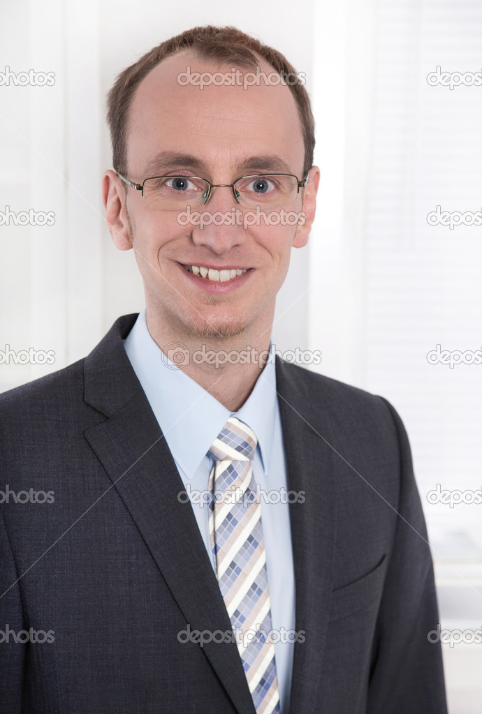 Portrait of a young smiling businessman or engineer with glasses