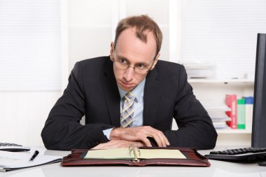 Businessman at desk with problems, stress and overworked sitting clipart