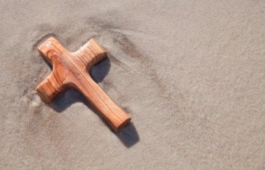 Wooden cross on beach clipart
