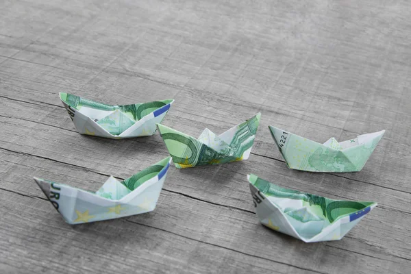 Paper boats folded out of money — Stock Photo, Image