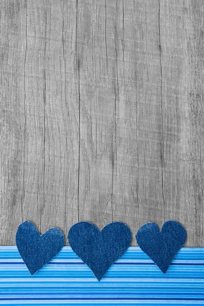 Denim hearts on wooden background — Stock Photo, Image