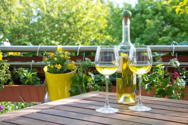 White wine served for two in garden.