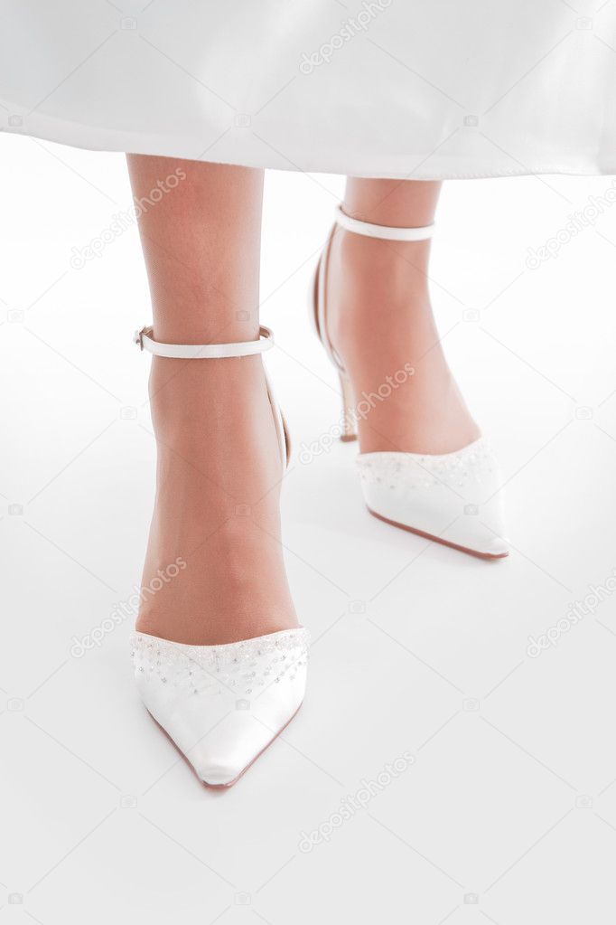 Bride's feet, shoes, flooring, dress.