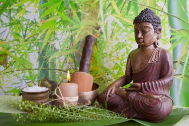 Buddha figurine with bath salt and a candle
