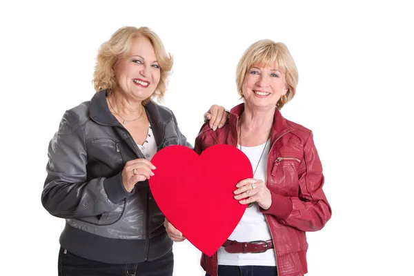 Women standing with a big hear-shape — Stock Photo, Image