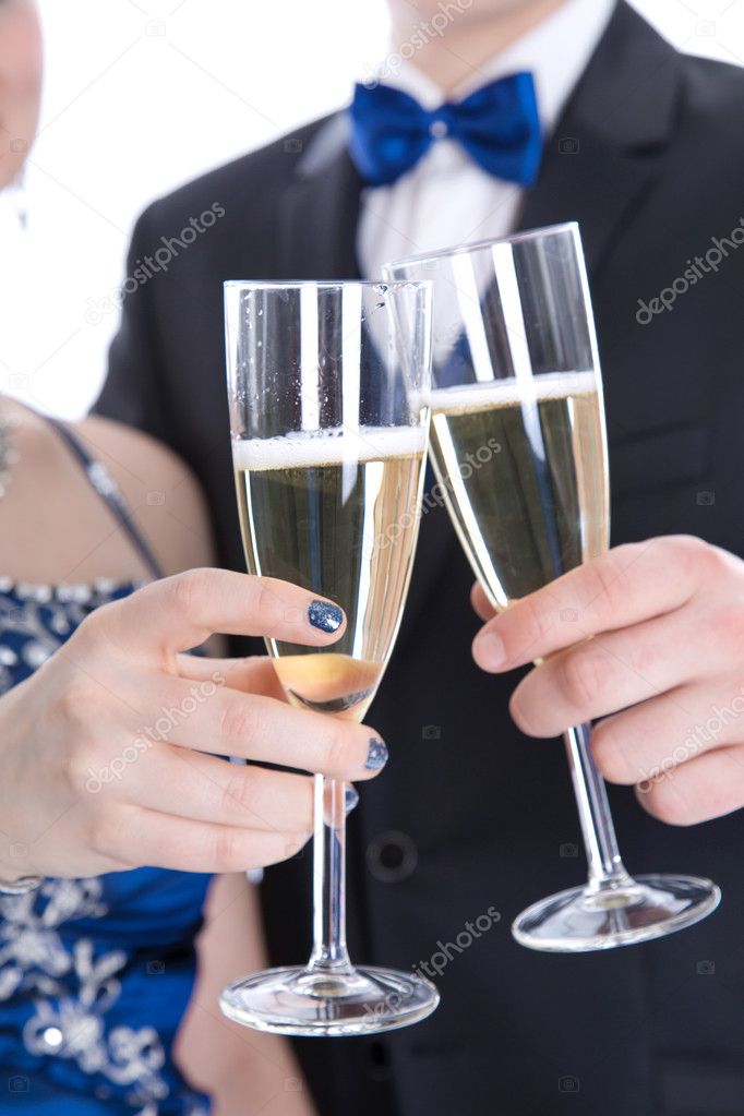 Carnival: young couple isolated on white drinking champagne