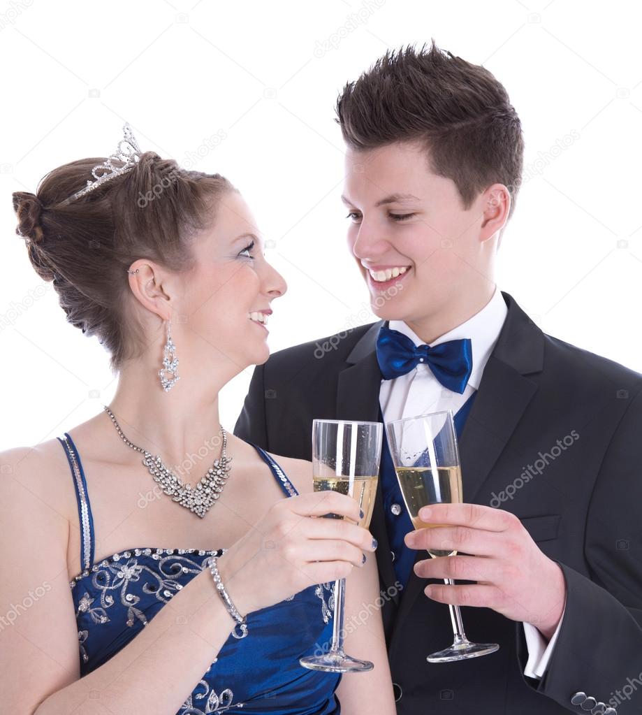 Carnival: young couple isolated on white drinking champagne