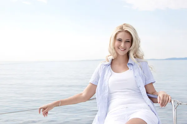 Portret van blond mooie jonge vrouw op zeilboot. — Stockfoto