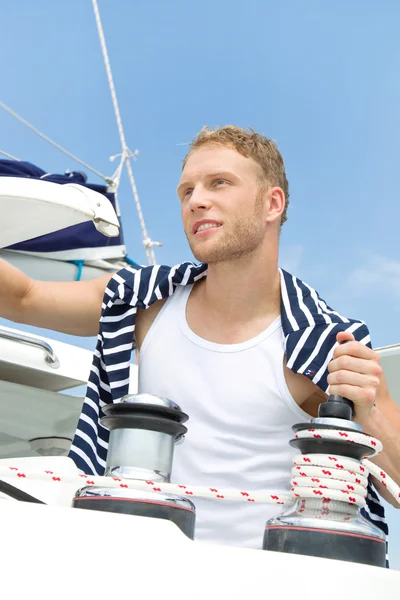 Portrait of blond handsome young man on sailing boat. — Stock Photo, Image