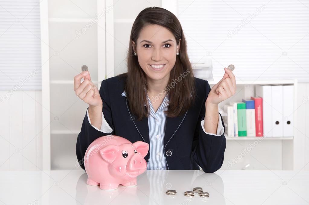 Young pretty business woman count money - coins with a piggy ban