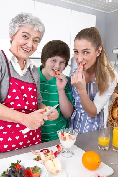 Happy family cooking together - with the grandmother — Stock Photo, Image