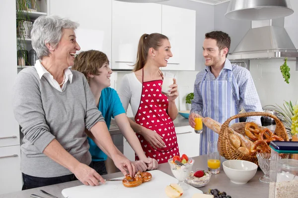 Gelukkige familie koken samen - met de grootmoeder. — Stockfoto