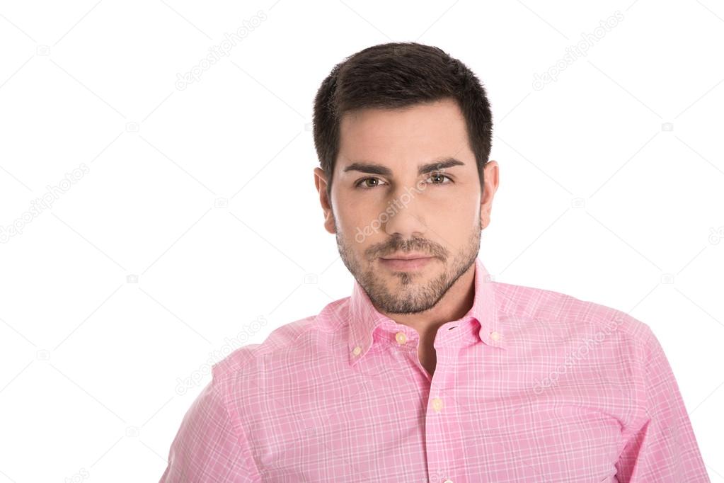 Portrait of attractive young man in a pink shirt isolated on white.