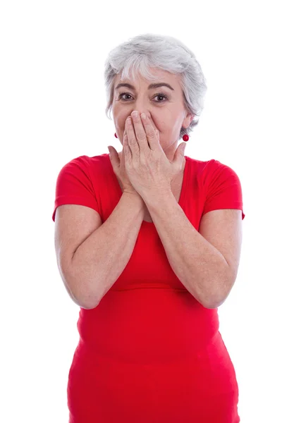 Mature woman in a red shirt shocked and isolated on white. — Stock Photo, Image