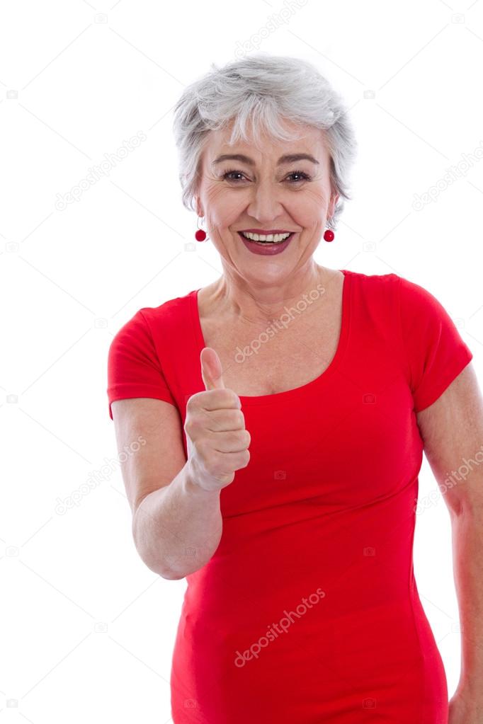 Powerful and successful older woman - thumbs up isolated on whit