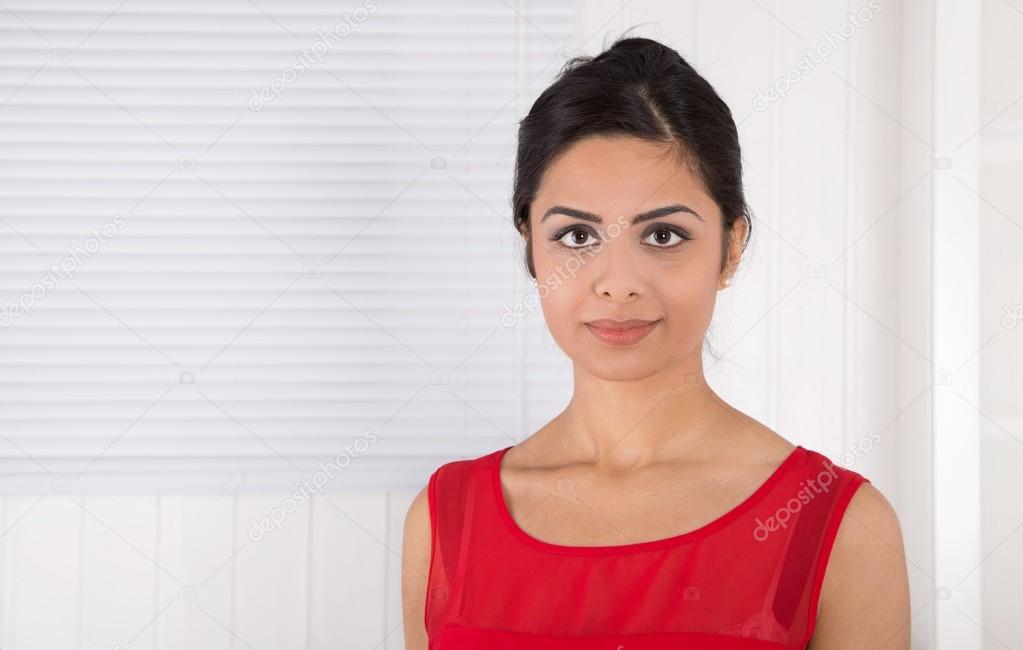 Portrait of attractive young indian woman in red.