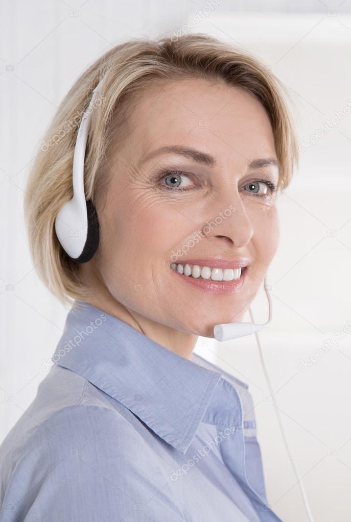 Portrait of smiling woman with headphone on telesales.