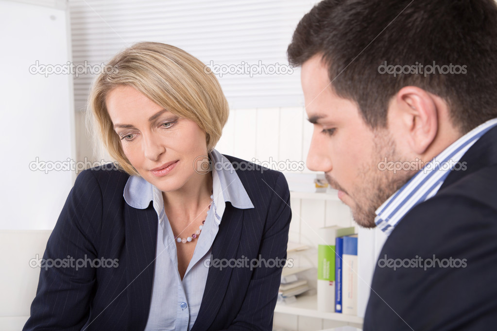 Consultation at office between businesswoman and customer.