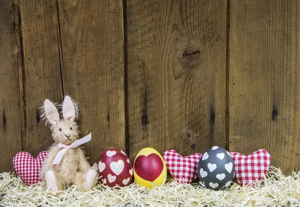 Rustic easter wooden background for a greeting card with eggs, h — Stock Photo, Image