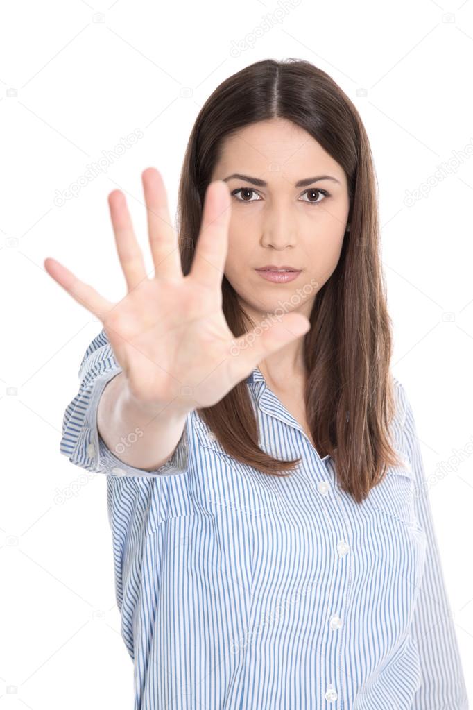 Portrait of young woman making stop sign with her hand.