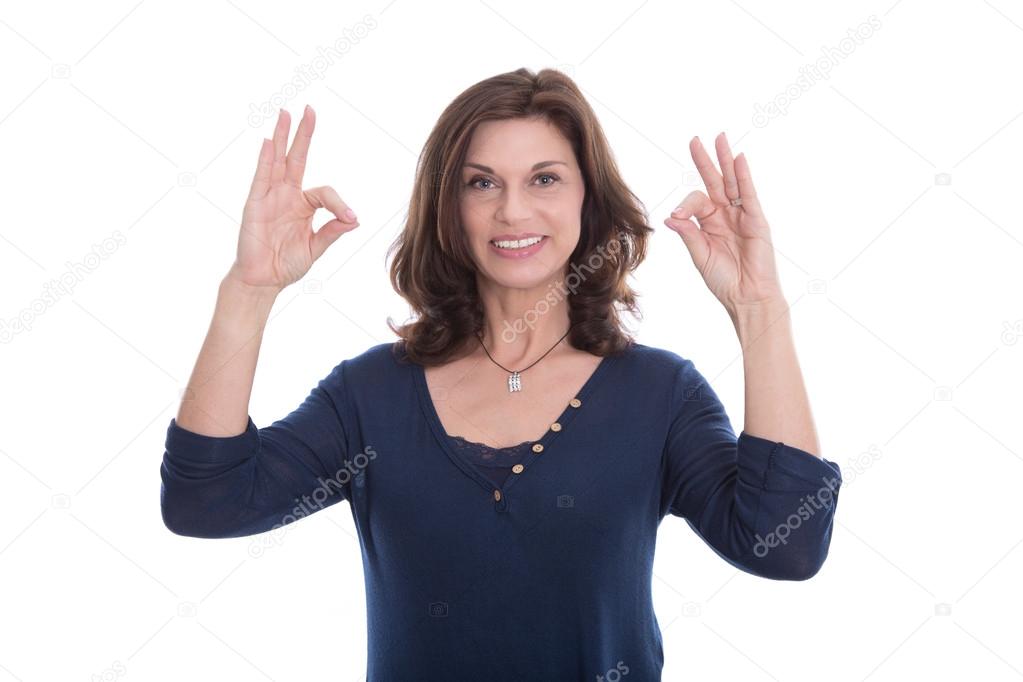 Smiling senior woman showing sign excellent with her fingers.