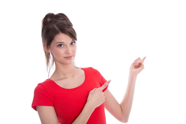 Isolé heureuse adolescente en rouge pointant avec son doigt . — Photo
