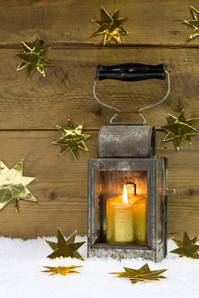 Metal lantern with wrapped gold presents and stars. — Stock Photo, Image